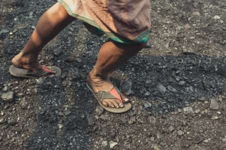 Coal workers wear non-protective open sandal style shoes as they work Coal workers at Dhaka, Bangladesh wear non-protective open sandal style shoes as they work.