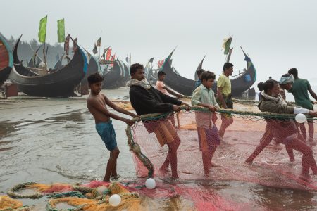 Villagers pulling along a fishing net at the Bay of Bengal Dragging fishing nets at the Bay of Bengal, Cox’s Bazar Bangladesh