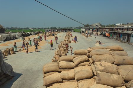 A view of the rice mill where families live and work together Families and workers gather at Rice Mills in Dhaka, Bangladesh.